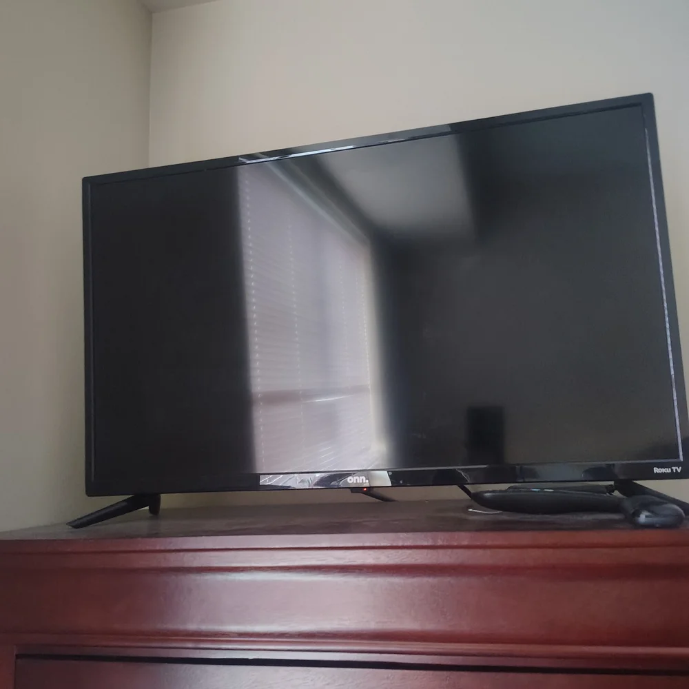 On Running Black Flat-Screen TV with Stand
